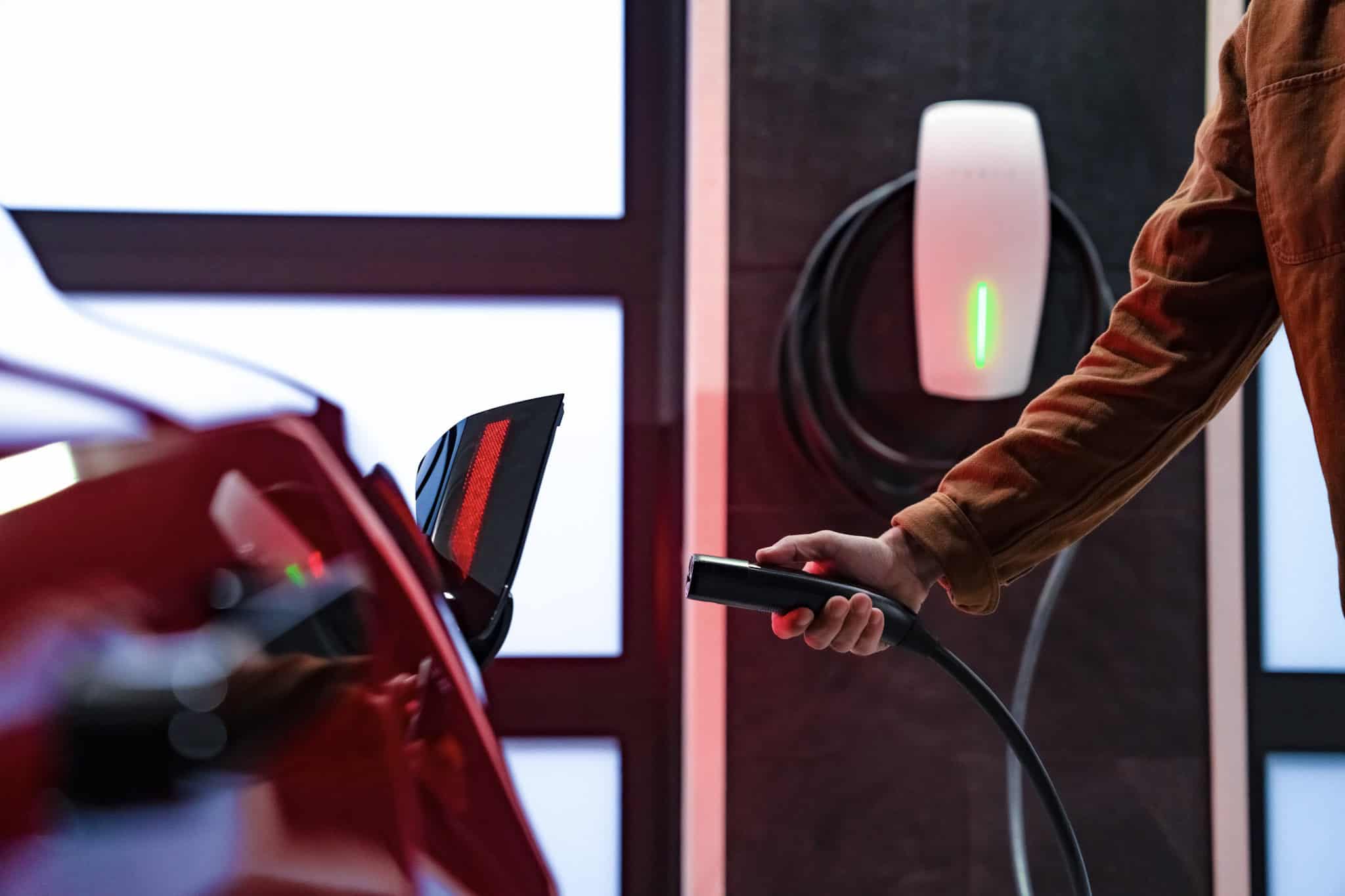 EV charger being plugged into an electric vehicle.