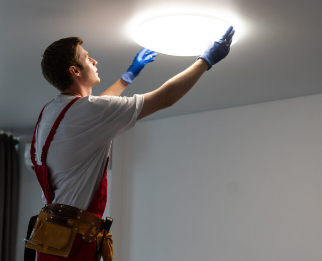 Electrician changing a light fixture.