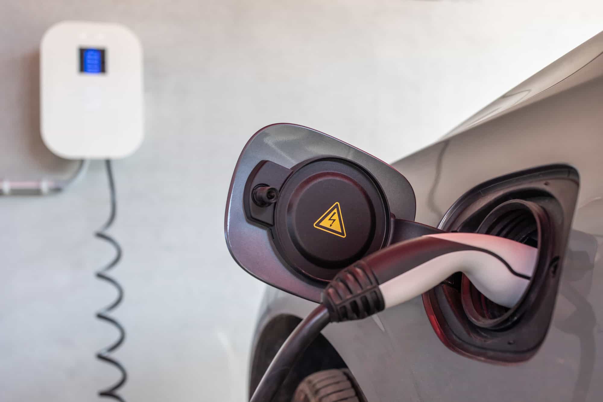 EV charger plugged into electric car.