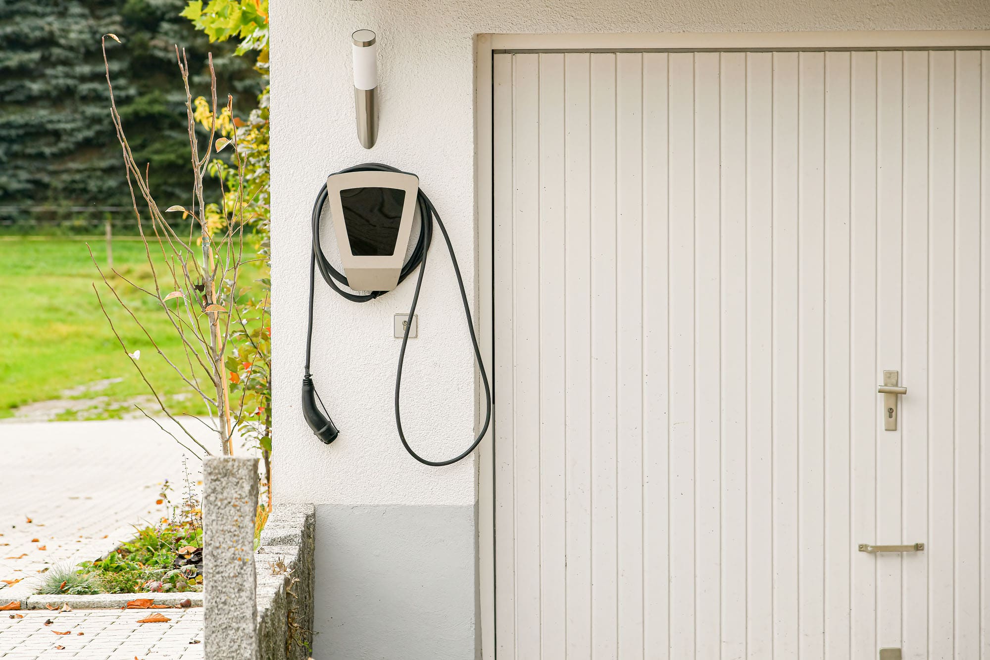 Legrand EV plugged into the wall of a house to charge an electric car.