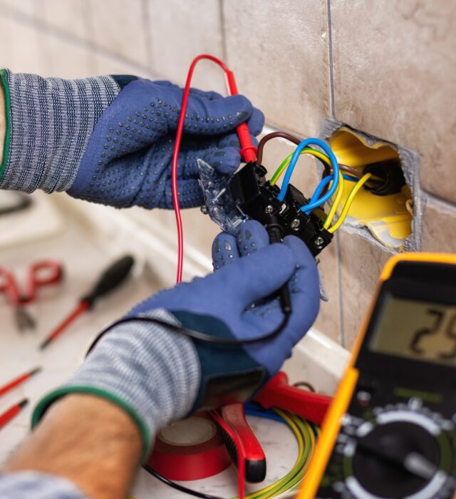 Residential electrician working on an outlet
