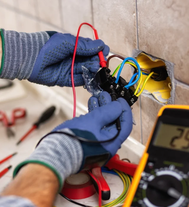 Residential electrician working on an outlet